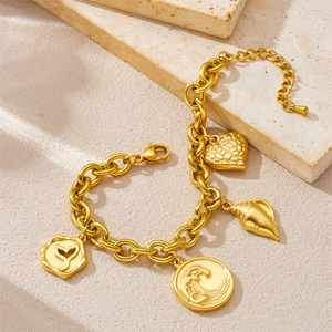 Gold-plated stainless steel chunky bracelet with sea wave, conch, and whale tail charms