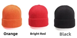 Detail view of ribbed knit beanies in vibrant orange, deep red, and classic black colors