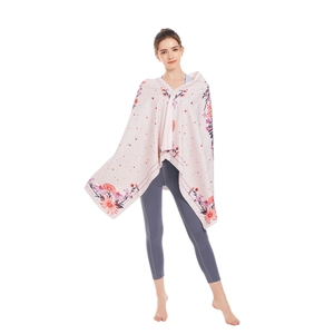 Microfiber beach towel with floral print shown on a model against a white background