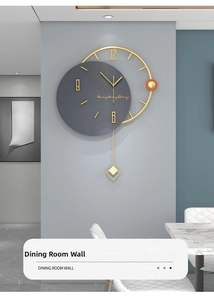 Detail view of modern grey silent wall clock with gold frame and metal pendulum