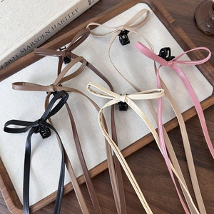 Morandi colors bow hair claw clips with long ribbons displayed on a wooden tray