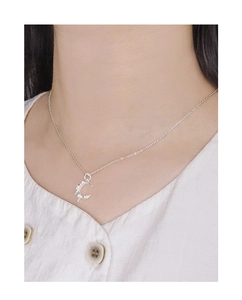 Close-up of S925 silver moon necklace with sparkling cubic zirconia on neck