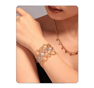 Close-up of dual-tone twisted rope bracelets in 18K gold and silver stainless steel