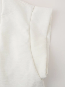 Detailed macro view of white sleeveless vest showing fine horizontal pleated texture and stitching