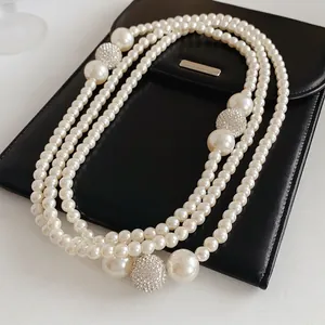 Three-layer layered pearl necklace with oversized pearls and pavé diamond spheres