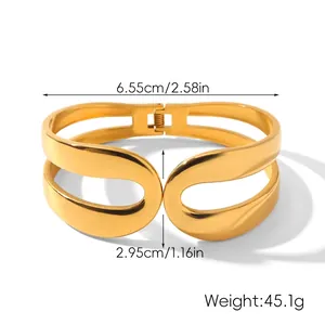 Macro view of wide gold open bangle with dual layer hollow arc design and dimensions
