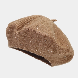 Detailed close-up of brown knit beret with sparkling silver sequins and ribbed texture