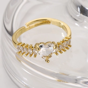 Adjustable gold ring featuring heart and marquise cut cubic zirconia gemstones