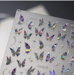 Macro shot of holographic butterfly nail stickers with iridescent laser finish and stars