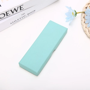 Detailed view of a light green textured jewelry gift box with a clean minimalist background