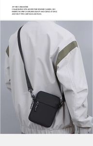 Rear view of a functional black nylon crossbody bag worn over a grey jacket for daily commuting