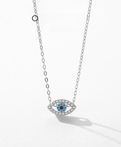 Macro shot of S925 sterling silver evil eye pendant with pavé set blue and white zircons