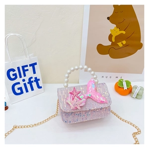 Detail of pink sequin mermaid princess bag with pearl handle and golden chain