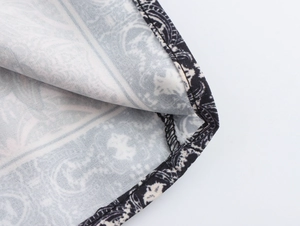 Macro shot of precise stitching and hem finish on ethnic print long sleeve blouse