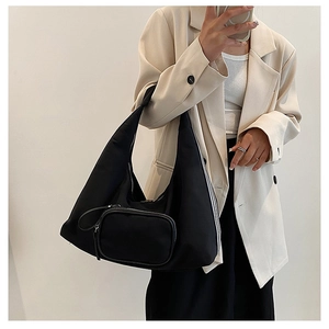 Close-up of black nylon hobo bag featuring a detachable small coin purse on the shoulder strap