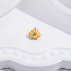 Macro shot of gold S925 sterling silver crown cap with beadwork and hanging loops
