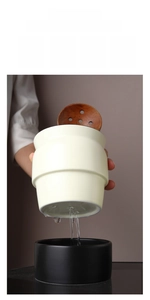 Ceramic utensil holder with drainage holes, tray, and dishwasher safe icons