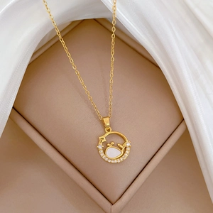 Elegant gold whale necklace with mother-of-pearl and zircons in a circular pendant