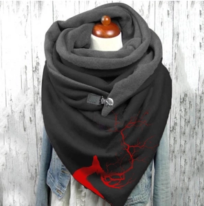 Detail of warm black shawl with red branch pattern and stylish leather buckle closure