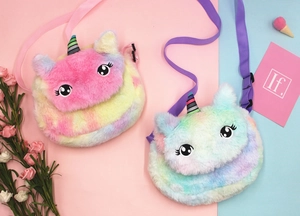 Detail of plush unicorn crossbody bags in pink and blue with soft texture and embroidery