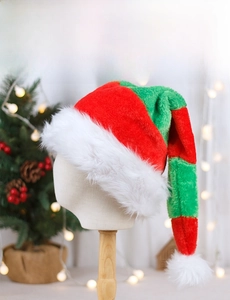 Detail of red and green striped Christmas elf hat with soft plush trim and pom-pom