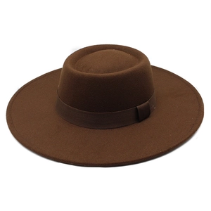 Macro shot of dark brown wool felt bolero hat showing smooth texture and matching ribbon