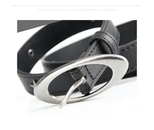 Detail of vintage silver crescent buckle and metal rivets on black punk leather belt