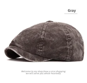 Detailed view of gray corduroy octagonal cap showing thick vertical texture and top button