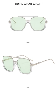 Detail of square double-bridge sunglasses with transparent green lenses and silver frame