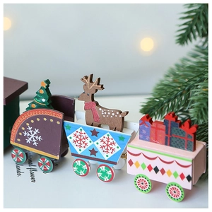Close-up of three-car wooden Christmas train with miniature trees and deer ornaments