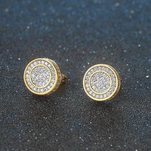 Macro shot of iced out round stud earrings with micro-paved cubic zirconia in gold