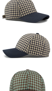 Detail of houndstooth baseball cap with solid color curved brim and woven texture