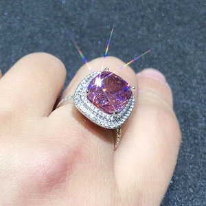 Macro detail of cushion cut pink zircon ring with double halo pavé setting and diamond band