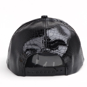 Detail of black faux crocodile texture snapback hat with adjustable plastic strap closure