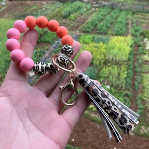 Detail of colorful silicone beaded keychain bracelet with leopard print tassel