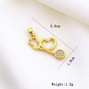 Macro shot of gold heart stethoscope pendant with dimensions 2.8cm and 1.2g weight