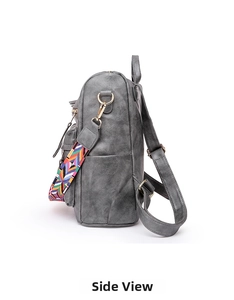 Side view of gray faux leather backpack featuring colorful woven strap and gold hardware