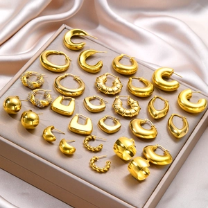 Collection of polished gold geometric earrings including C-shape and teardrop designs