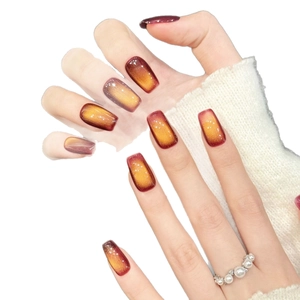 Faux ongles œil de chat dégradé rouge et doré avec paillettes et forme carrée allongée
