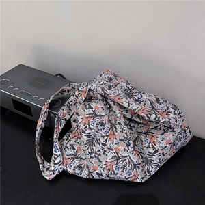 Detailed close-up of a floral cotton tote bag with vintage blue and orange patterns