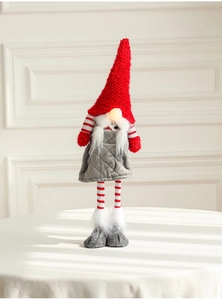 Detail of a Christmas gnome doll with long striped legs and knitted red hat decor