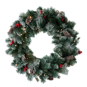 Christmas wreath with artificial pine needles, cones, red berries and warm LED lights