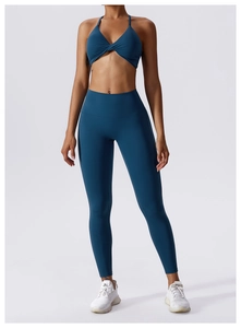 Detail of teal blue high-stretch yoga set with twist-front bra and high-waist leggings