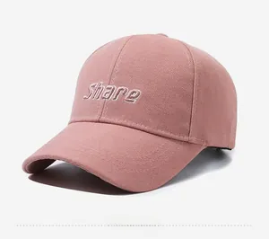 Side view of pink baseball cap with white Share embroidery and classic curved brim