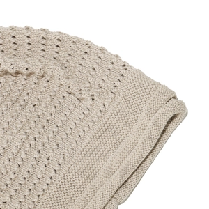 Detailed close-up showing the hollow diamond knit pattern on this beige winter beanie hat