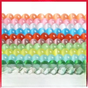 Detailed grid of colorful cat eye stone beads showing vibrant colors and unique light bands