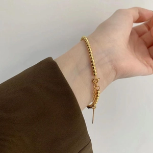 Minimalist 925 sterling silver golden bead bracelet shown worn on a female wrist
