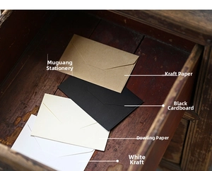 Mini vintage kraft envelopes in brown black cream and white on a rustic wooden drawer