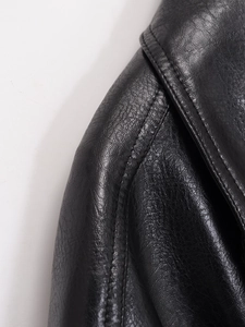 Detail of high collar stitching and fine leather texture on black bomber jacket