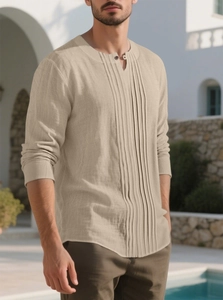 Detail of beige cotton linen shirt featuring a pleated chest and Henley neck design
